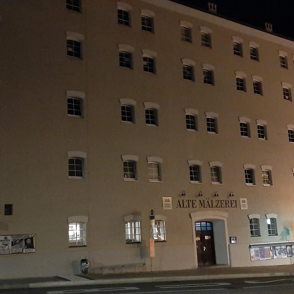 A tan building with many windows called